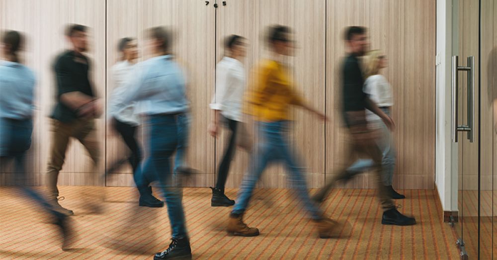 people walking in a corridor blurred