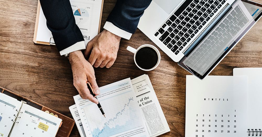 finance person looking at graphs on a table