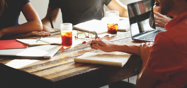 people planning a project sitting around a table