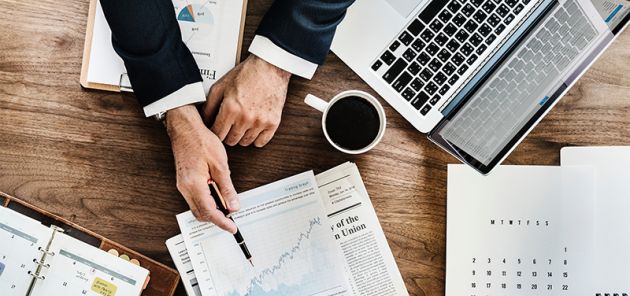 finance person looking at graphs on a table
