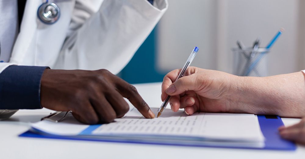 doctors looking at a paper audit on a clip board